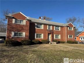 Dayton apartment for rent - A red brick house with a grey roof and a white door.