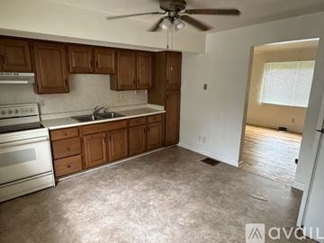 Dayton apartment for rent - A kitchen with wooden cabinets and a stainless steel oven.
