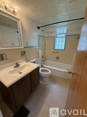 Dayton apartment for rent - A bathroom with a toilet, sink, and bathtub.