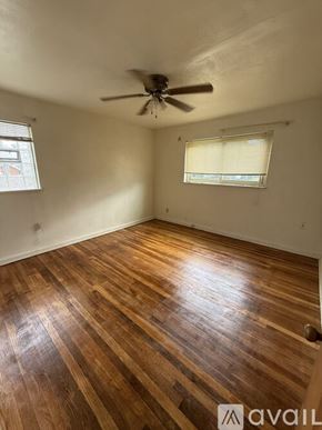 Dayton apartment for rent - A room with wooden flooring and a ceiling fan.