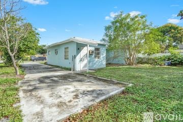 Lantana apartment for rent - A kitchen with a white counter and a ceiling fan.