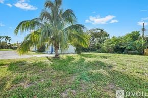 Lantana apartment for rent - A room with a ceiling fan and a door leading to another room.