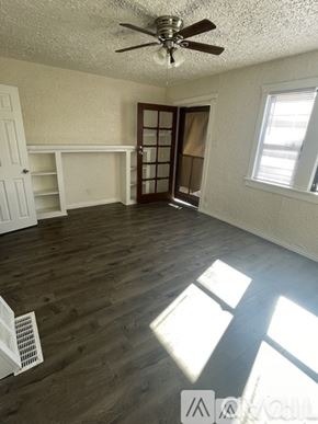 Los Angeles townhouse for rent - A room with a ceiling fan and wooden flooring.