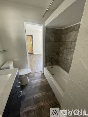 Los Angeles townhouse for rent - A bathroom with a toilet, sink, and bathtub.