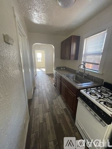 Los Angeles townhouse for rent - A kitchen with a white stove and wooden floors.