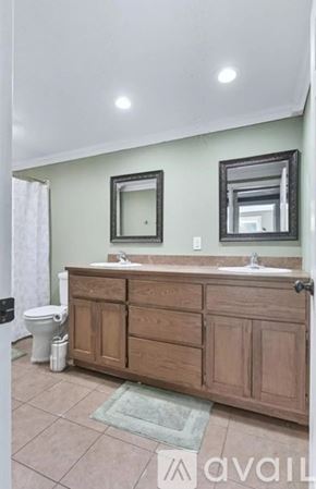 New Haven house for rent - A bathroom with a toilet, sink, and mirror.