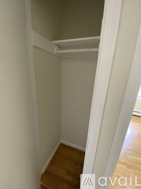 Boston apartment for rent - A room with a white wall and wooden floor.