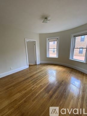 Boston apartment for rent - A room with wooden flooring and two windows.