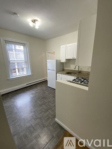 Boston apartment for rent - A kitchen with a refrigerator, sink, and cabinets.