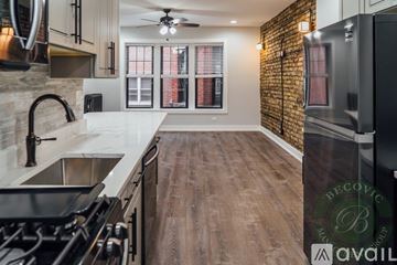 Chicago apartment for rent - A kitchen with a brick wall and wooden floors.