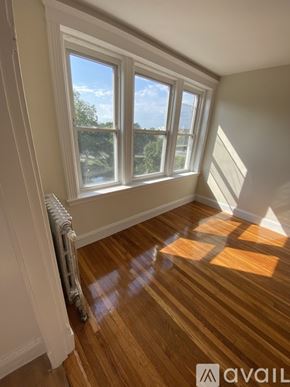 Boston apartment for rent - A room with a window and wooden flooring.