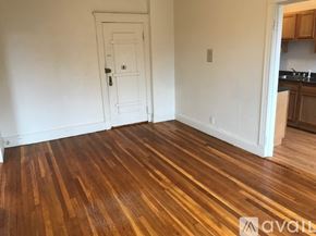 Boston apartment for rent - A room with wooden flooring and a white door.