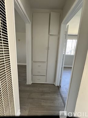 Los Angeles apartment for rent - A hallway with a white door and drawers.
