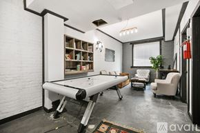 Chicago apartment for rent - A room with a pool table and a fire extinguisher on the wall.