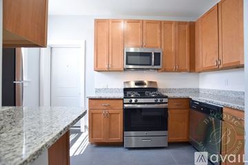 Chicago apartment for rent - A kitchen with wooden cabinets and granite countertops.