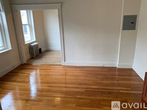 Boston apartment for rent - A room with wooden floors and white walls.