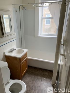 Boston apartment for rent - A bathroom with a toilet, sink, and bathtub.