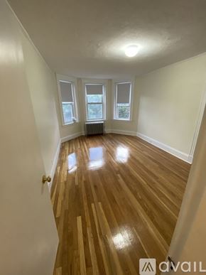 Boston apartment for rent - A room with wooden flooring and white walls.