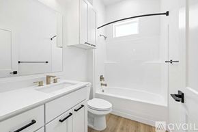 Caldwell house for rent - A white bathroom with a toilet, sink, and bathtub.