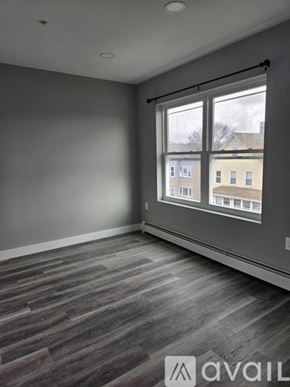 Everett apartment for rent - A room with grey walls and a window showing a view of buildings outside.