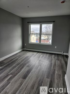 Everett apartment for rent - A room with grey walls and a large window with a view of a residential area.