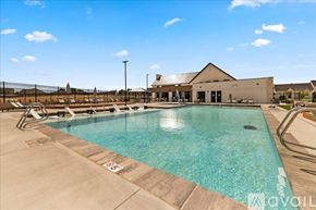 Caldwell house for rent - A large outdoor swimming pool with lane markers and a building in the background.