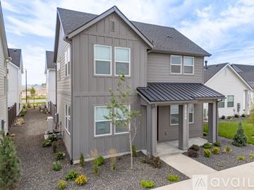 Caldwell house for rent - A kitchen with white cabinets and stainless steel appliances.