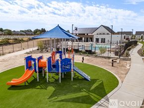 Caldwell house for rent - A playground with a blue canopy and orange and blue slides.