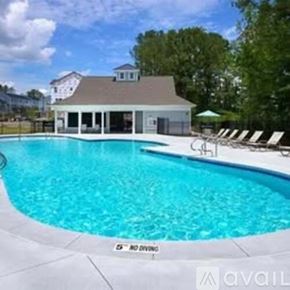 Apex apartment for rent - A pool with a house in the background.