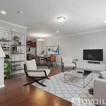 Apex apartment for rent - A living room with a white couch and a television.