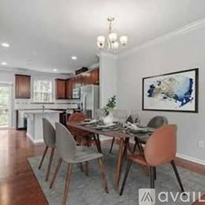 Apex apartment for rent - A dining room with a wooden table and chairs.