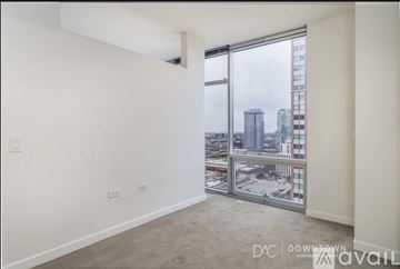 Chicago apartment for rent - A living room with a leopard print couch and a television on the wall.
