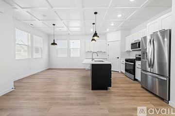 Caldwell house for rent - A kitchen with white cabinets and stainless steel appliances.