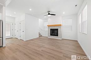 Caldwell house for rent - A spacious living room with a fireplace and wood flooring.