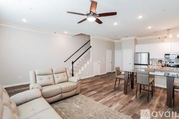 Denton townhouse for rent - A living room with a white sofa and a wooden floor.