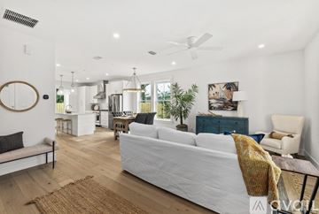 St. Augustine house for rent - A living room with a white couch and a wooden floor.