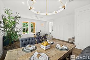 St. Augustine house for rent - A dining room with a wooden table set for a meal.