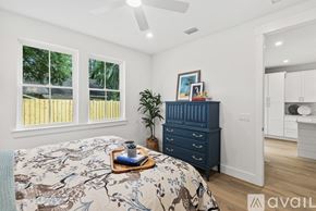 St. Augustine house for rent - A bedroom with a bed, dresser, and ceiling fan.