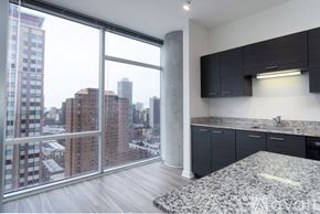 Chicago apartment for rent - A kitchen with a marble countertop and a view of the city.