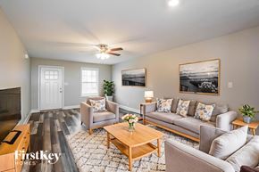 Clarksville house for rent - A living room with a couch, chairs, and a coffee table.