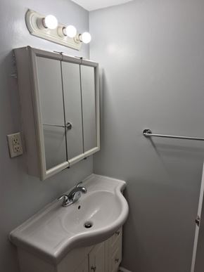 Dartmouth apartment for rent - A white sink in a bathroom with a mirror above it.