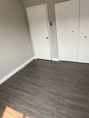 Kingston apartment for rent - A room with a grey floor and two white doors.