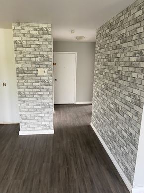 Kingston apartment for rent - A room with a white door and a brick wall.