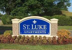 Richmond apartment for rent - A sign for St. Luke Apartments is surrounded by shrubbery.