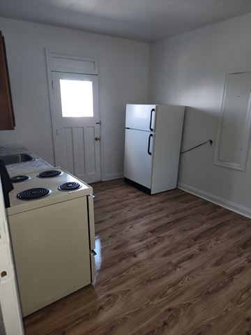Cornwall apartment for rent - A kitchen with a stove, refrigerator, and cabinets.