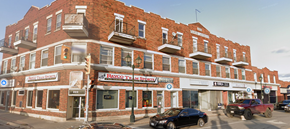 Cornwall apartment for rent - A red brick building with a black car parked in front.