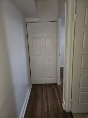 Cornwall apartment for rent - A white door is in a hallway with a wooden floor.