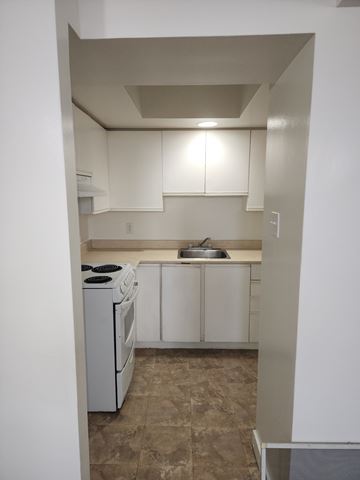 Cornwall apartment for rent - A small kitchen with a washing machine and a sink.