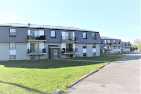 Amherstview apartment for rent - A row of townhouses with balconies and green lawns.