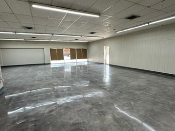 Bay City apartment for rent - A spacious empty room with grey flooring and white walls.